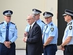 Australian Prime Minister Anthony Albanese, center, is briefed by police after laying flowers at the Bondi Pavilion, a day after a shooting at Bondi Beach in Sydney, on Monday.