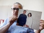 FILE PHOTO: Taghi Ramahi, husband of Narges Mohammadi, a jailed Iranian women's rights advocate, who won the 2023 Nobel Peace Prize, poses with an undated photo of himself and his wife, during an interview at his home in Paris, France, October 6, 2023. REUTERS/Christian Hartmann/File Photo