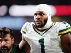 Green Bay Packers defensive end Micah Parsons (1) walks off the field with help from medical personnel