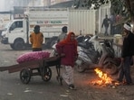 A vegetable vendor pulls a cart during a cold and smoggy winter morning, in New Delhi, Sunday, Dec. 14, 2025. 