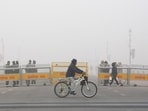 A cyclist passes by security barricades along a fog-covered Kartavya Path on a cold winter morning in New Delhi, Monday. A cyclist passes by security barricades along a fog-covered Kartavya Path on a cold winter morning in New Delhi, Monday.