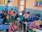 Students of a government primary school appearing for a unit test in Ludhiana on Monday. (HT Photo)