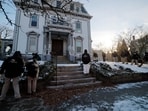 An FBI Evidence Response Team searches the grounds around the site of the Brown University shooting.