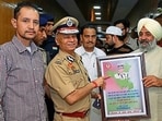 Visitors give a token of appreciation to DGP Singh at his public redress session on Sunday. (HT Photo)