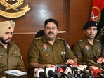 Mohali senior superintendent of police Harmandeep Singh Hans (centre) addressing a press conference on Tuesday. (Sanjeev Sharma/HT)