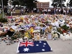 Mourners gather around floral tributes at Bondi Pavilion to honor the victims of the Bondi Beach shooting in Sydney on December 16, 2025.