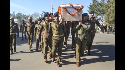 J&K director general of police Nalin Prabhat with other security personnel carries the mortal remains of Special Operations Group cop Amjad Ali Khan, who was killed during a gunfight with terrorists, in Udhampur district. (PTI)