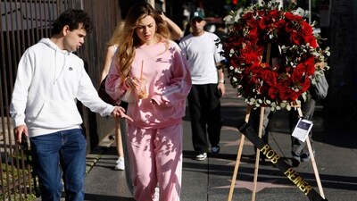 LOS ANGELES, CALIFORNIA - DECEMBER 15: People cross famed director Rob Reiner's star adorned with flowers on the Hollywood Walk of Fame on December 15, 2025 in Los Angeles, California. (Photo by MARIO TAMA / GETTY IMAGES NORTH AMERICA / Getty Images via AFP) (Getty Images via AFP) LOS ANGELES, CALIFORNIA - DECEMBER 15: People cross famed director Rob Reiner's star adorned with flowers on the Hollywood Walk of Fame on December 15, 2025 in Los Angeles, California. (Photo by MARIO TAMA / GETTY IMAGES NORTH AMERICA / Getty Images via AFP) (Getty Images via AFP)