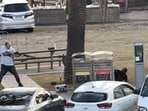 A gunman lies on the ground after being disarmed in Bondi Beach, Sydney, Australia, December 14, 2025, in this screengrab from video.  