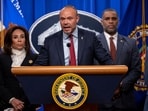 Deputy FBI Director Dan Bongino (C) speaks during a news conference at the Department of Justice Deputy FBI Director Dan Bongino (C) speaks during a news conference at the Department of Justice
