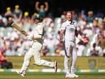 Australia's Alex Carey celebrates after reaching his century as England's Ben Stokes reacts