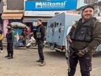 Security personnel stand guard during a raid by the counter intelligence unit of Kashmir in Srinagar on Tuesday. (PTI)