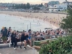 Beach-goers fleeing Bondi Beach after gunmen opened fire, in Sydney on December 14, 2025