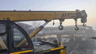 A crane is deployed to remove charred buses after a fog-hit pile-up sparked fire on the Yamuna Expressway, in Mathura on Tuesday. (PTI PHOTO) A crane is deployed to remove charred buses after a fog-hit pile-up sparked fire on the Yamuna Expressway, in Mathura on Tuesday. (PTI PHOTO)