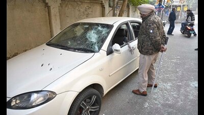A policeman inspects the vandalised car vehicles outside the court complex in Ludhiana on Wednesday. (Gurpreet Singh/HT) A policeman inspects the vandalised car vehicles outside the court complex in Ludhiana on Wednesday. (Gurpreet Singh/HT)