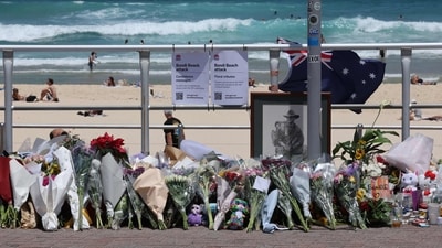 Floral tributes left by mourners at the promenade of Bondi Beach in Sydney on December 17, 2025, in honour of victims of the shooting that took place there on December 14. (AFP)