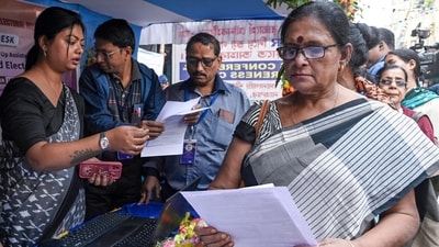 Bengal SIR draft rolls: People enrol at a Special Intensive Revision (SIR) of electoral rolls camp at the Sonagachi area, in Kolkata. (PTI) Bengal SIR draft rolls: People enrol at a Special Intensive Revision (SIR) of electoral rolls camp at the Sonagachi area, in Kolkata. (PTI)