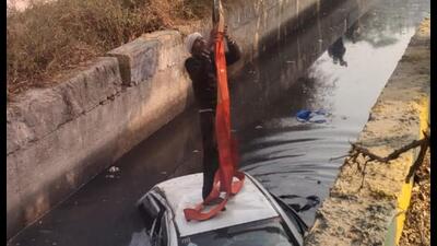 The Maruti Suzuki Swift was retrieved using a hydraulic crane after hours of effort. Due to onlookers, traffic was briefly affected in the area around 8 am. (HT Photos) The Maruti Suzuki Swift was retrieved using a hydraulic crane after hours of effort. Due to onlookers, traffic was briefly affected in the area around 8 am. (HT Photos)