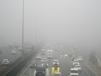 A thick layer of fog reduces visibility near Signature Tower chowk in Gurugram on Thursday. (Parveen Kumar/HT) A thick layer of fog reduces visibility near Signature Tower chowk in Gurugram on Thursday. (Parveen Kumar/HT)