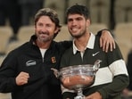 Carlos Alcaraz, right, poses with Juan Carlos Ferrero after winning the French Open in June 2025. (AP)