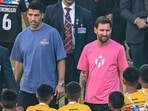 Argentina's footballer Lionel Messi (C), along with Uruguayan footballer Luis Suarez (L)