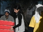 Roshy Chhillar distributing blankets at a shelter home in Gurugram on Thursday. (Parveen Kumar/HT Photo)