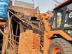 An illegal building being demolished by the MC in Ludhiana on Friday. (HT Photo)