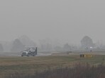 First responders tend to the scene of the plane crash on which Greg Biffle and his family were traveling. 