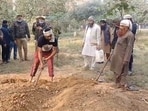 The body being exhumed at a graveyard in Hapur. (Sourced)