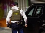 Local, state and federal law enforcement agents, including the FBI, take part in the search for the Brown University shooter, in Salem, New Hampshire, U.S., December 18, 2025.   REUTERS/CJ Gunther