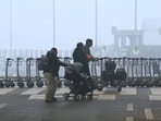 Morning chill and fog engulf the Delhi airport as passengers arrive to board flights.