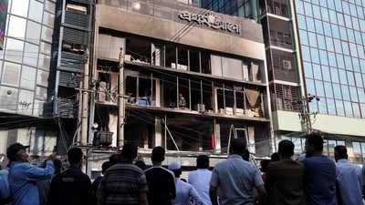 People gather to look at the building of the vandalised office of Prothom Alo newspaper, following the death of Sharif Osman Hadi, a student leader, who was undergoing treatment in Singapore after being in shot the head, in Dhaka, Bangladesh. (REUTERS)