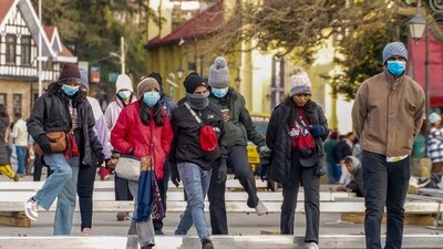 Tourists take a stroll on a cold winter day, in Shimla. (PTI) Tourists take a stroll on a cold winter day, in Shimla. (PTI)