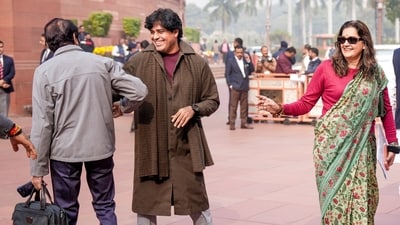 Priyanka Chaturvedi and Congress MP Imran Pratapgarhi exchange smiles on the last day of the winter session of the parliament. (Ravi Choudhary/PTI)
