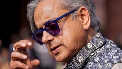 Congress MP Shashi Tharoor reaches the parliament premises on the last day of the winter session in New Delhi. (PTI)