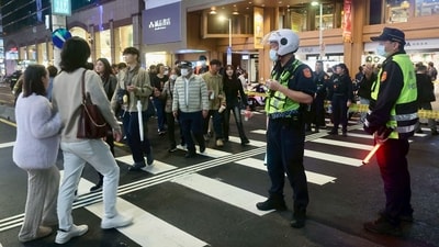 This picture taken and released by Taiwan's Central News Agency (CNA) on December 19, 2025 shows police directing pedestrian traffic in Taipei after attacks at two metro stations in the city. Attacks at metro stations in Taipei on December 19 involving smoke bombs and stabbing killed at least two people, a fire department official told AFP, adding that the suspect was also dead. (AFP) This picture taken and released by Taiwan's Central News Agency (CNA) on December 19, 2025 shows police directing pedestrian traffic in Taipei after attacks at two metro stations in the city. Attacks at metro stations in Taipei on December 19 involving smoke bombs and stabbing killed at least two people, a fire department official told AFP, adding that the suspect was also dead. (AFP)
