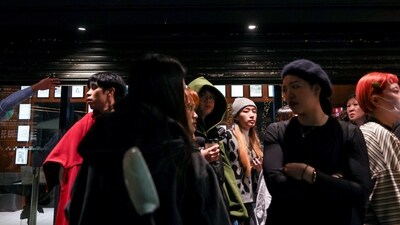 Staff from Eslite Spectrum Nanxi store near Zhongshan station wait to return to the building to collect their personal belongings while the building is cordoned off with yellow crime scene tape, following an incident in which several were injured after a person released smoke bombs and attacked bystanders, according to the government and local media, in Taipei, Taiwan, December 19, 2025.&nbsp; (REUTERS)