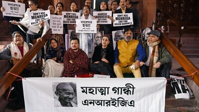 MPs of Trinamool Congress (TMC) hold banners and stage protest over the MGNREGA issue at Parliament premises on Friday as the winter session drew an end. (Jitender Gupta/ANI)