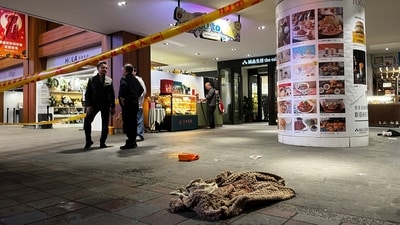 A piece of cloth lies outside Eslite Spectrum Nanxi store near Zhongshan station as the entrance of the building is cordoned off with yellow crime scene tape, following an incident in which several were injured after a person released smoke bombs and attacked bystanders, according to the government and local media, in Taipei, Taiwan, on December 19, 2025. (REUTERS)