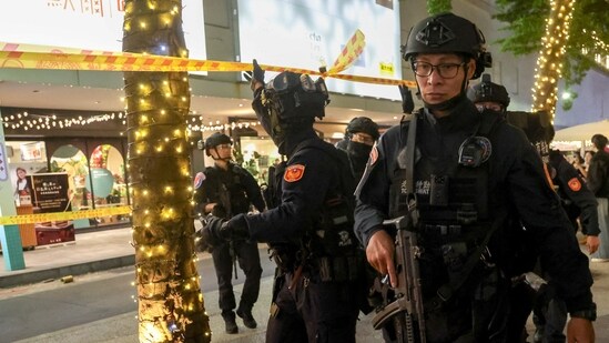 SWAT team members leave Eslite Spectrum Nanxi store near Zhongshan station while the building is cordoned off with yellow crime scene tape, following an incident in which several were injured after a person released smoke bombs and attacked bystanders, according to the government and local media, in Taipei, Taiwan, December 19, 2025.(REUTERS)