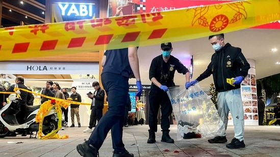 Police collect evidence from a crime scene outside Eslite Spectrum Nanxi store near Zhongshan station as the entrance of the building is cordoned off with yellow crime scene tape, following an incident in which several were injured after a person released smoke bombs and attacked bystanders, according to the government and local media, in Taipei, Taiwan, December 19, 2025.(REUTERS)