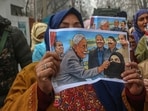 People's Democratic Party (PDP) Supporters hold placards during a protest against Bihar Chief Minister Nitish Kumar over hijab issue.
