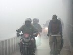 Commuters brave dense fog on a winter morning, in New Delhi. Commuters brave dense fog on a winter morning, in New Delhi.