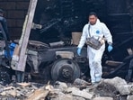 Members of the Attorney General's Office and forensic investigators work at the crash site of a Greg Biffle plane crash. (Photo by MARIO VAZQUEZ / AFP)