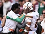 Former Miami Hurricanes player Michael Irvin celebrates with Miami Hurricanes defensive back Jakobe Thomas
