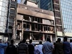 People gather to look at the building of the vandalised office of Prothom Alo newspaper, following the death of Sharif Osman Hadi, a student leader, who was undergoing treatment in Singapore after being in shot the head, in Dhaka, Bangladesh, on Friday. (REUTERS)