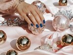 Modern Christmas nail designs focus on creativity and elegance, with options like plaid patterns, soft green shades, and minimalist accents.(Pexels)