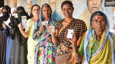 People wait in a queue to cast their votes at a polling booth during the Maharashtra local body elections, in Karad, Tuesday, Dec. 2, 2025. (PTI)