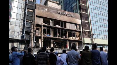People gather to look at the building of the vandalised office of Prothom Alo newspaper, following the death of Sharif Osman Hadi, a student leader, who was undergoing treatment in Singapore after being in shot the head, in Dhaka, Bangladesh, on Friday. (REUTERS)