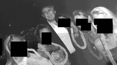 President Donald Trump (C) posing with a group of women wearing Hawaiian-style leis (AFP)